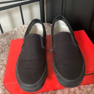 All black slip on vans